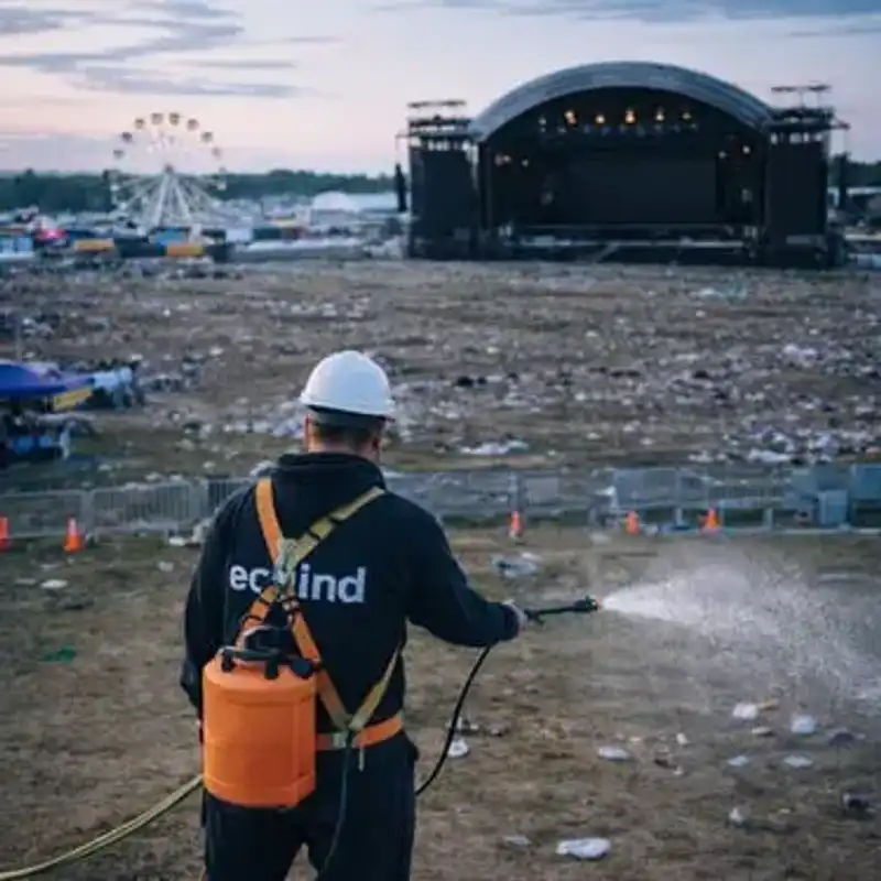 Personal de limpieza recogiendo residuos tras un evento masivo en un recinto deportivo